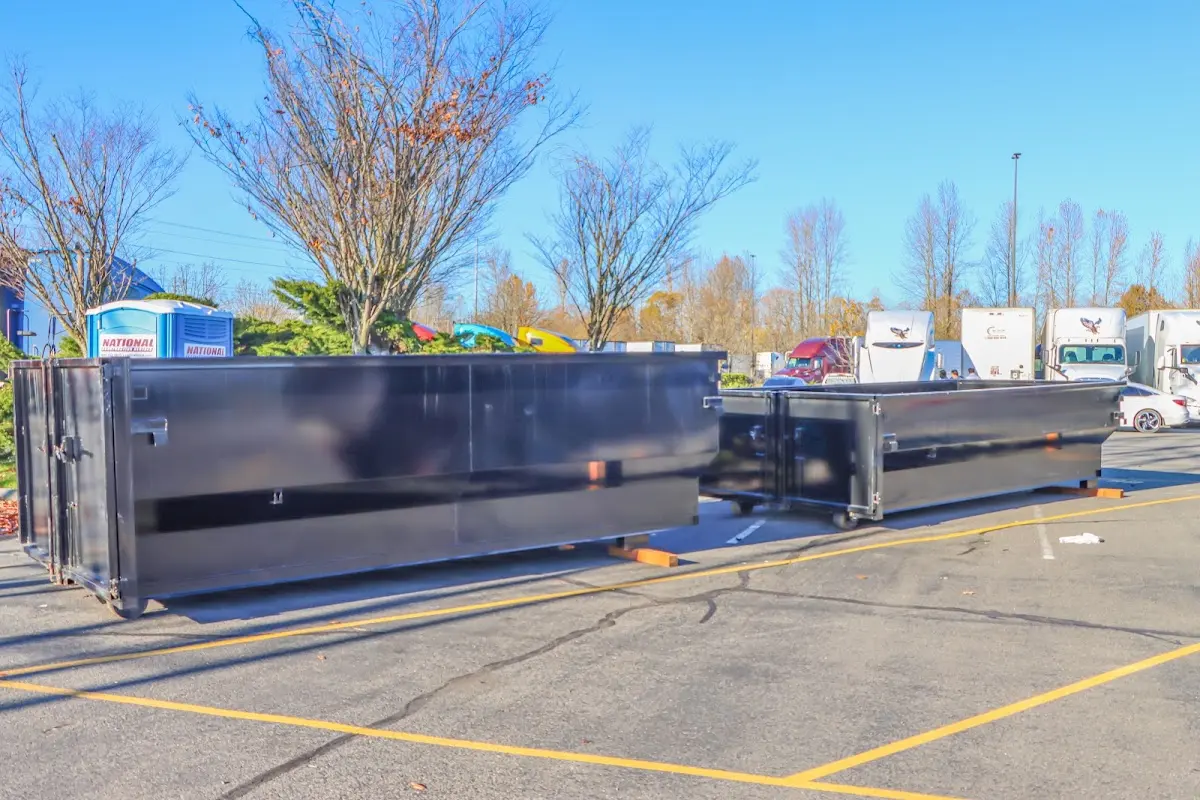 Professional dumpster rental service with roll-off container on residential driveway in Norwalk